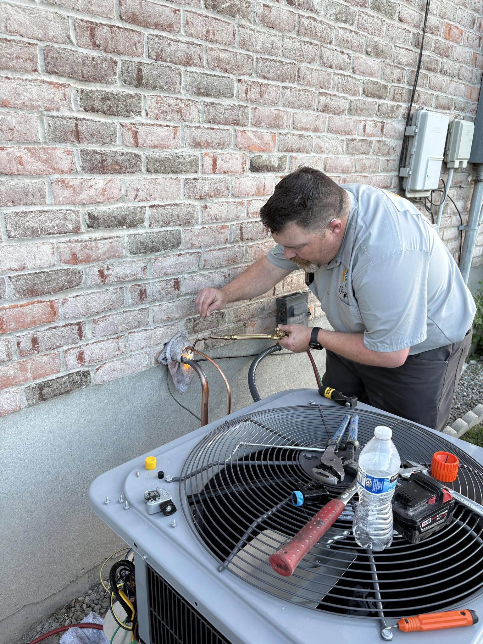 Outdoor AC condenser serviced by Sullys Heating and Air